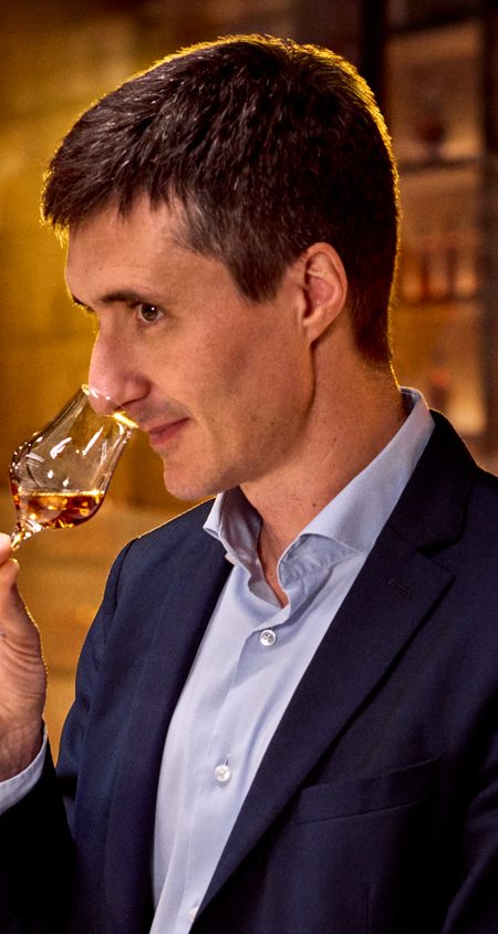 Photo of Christophe Valtaud, the cellar master, smelling a glass of Cognac